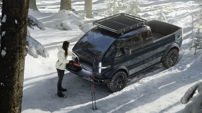 Canoo pickup truck parked in snow.
