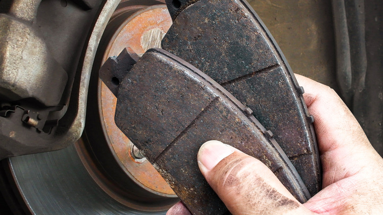 A hand holding brake pads