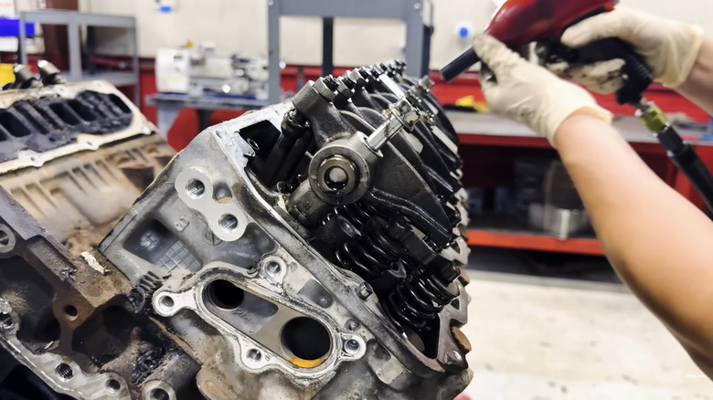 An engine expert takes apart an LBZ engine for maintenance