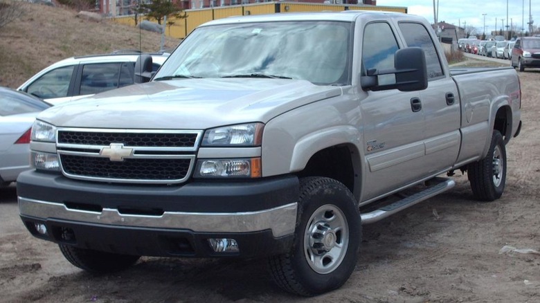A 2004-2006 Chevy Silverado 2500HD parked on dirt on a dull day