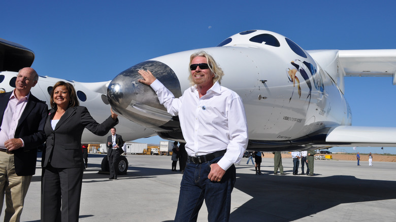 Richard Branson poses before aircraft