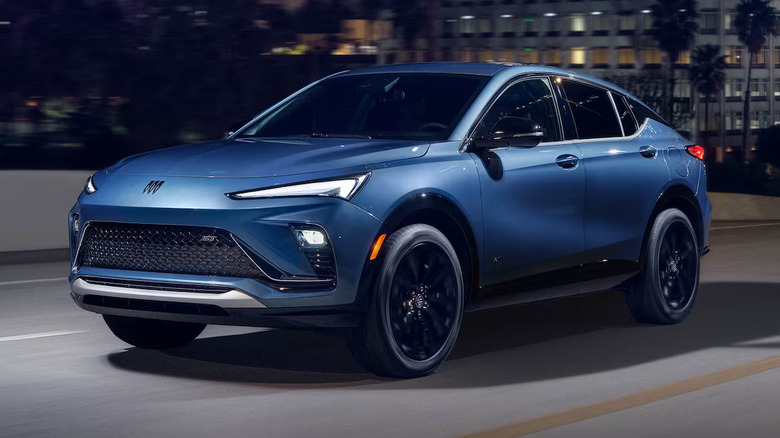 Blue 2026 Buick Envista driving down a city highway at night