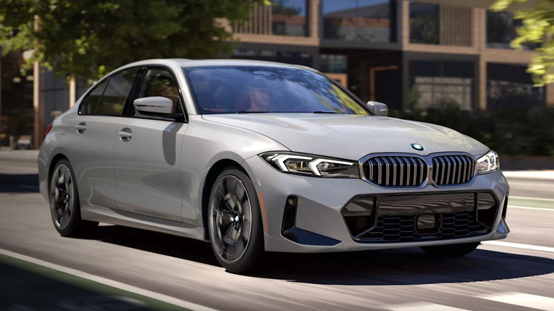 Person driving a BMW 3 Series in a city