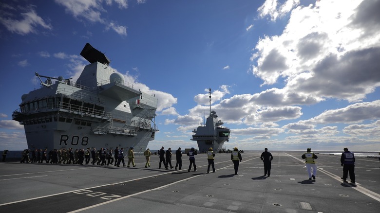 Royal Navy aircraft carrier crews doing a FOD walk