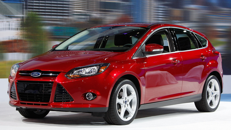 A red Ford Focus on display at an auto show.