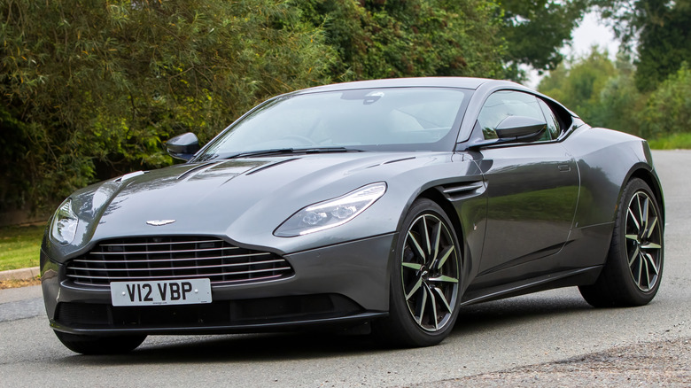 A gray Aston Martin DB11 on a road