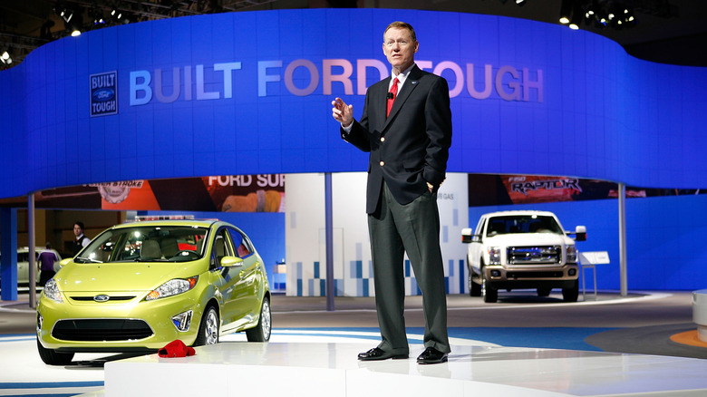 Alan Mulally, Ford CEO 2006-2014, addressing an audience at an auto show.