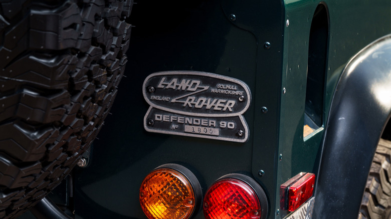 Close-up of a nameplate on a Land Rover Defender 90.