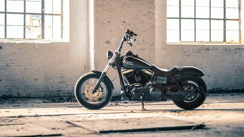 A Harley-Davidson Dyna photographed in a warehouse, side view