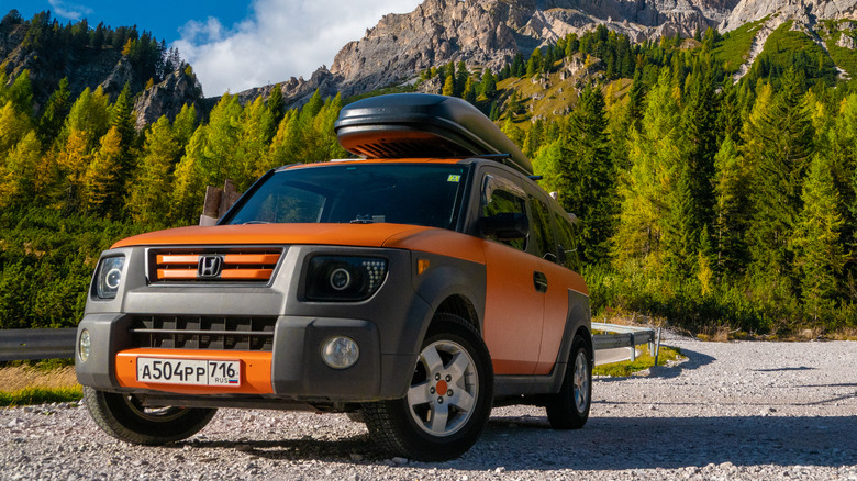 Bright orange Honda Element in the Alps