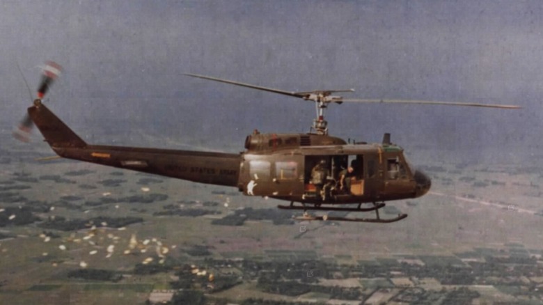 A Uh-1 Huey flying a propaganda mission over Vietnam in 1967