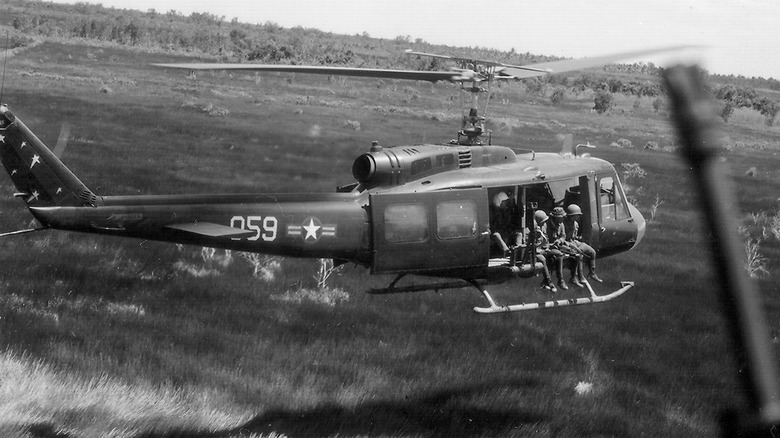 Vietnam Air Force personnel engaged in flight operations aboard a UH-1 in Vietnam in 1970