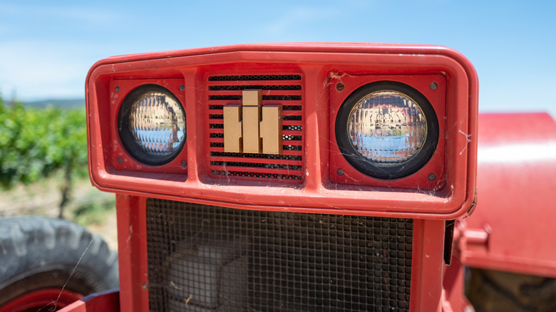 Close-up of a red International Harvester tractor's front grille with logo visible