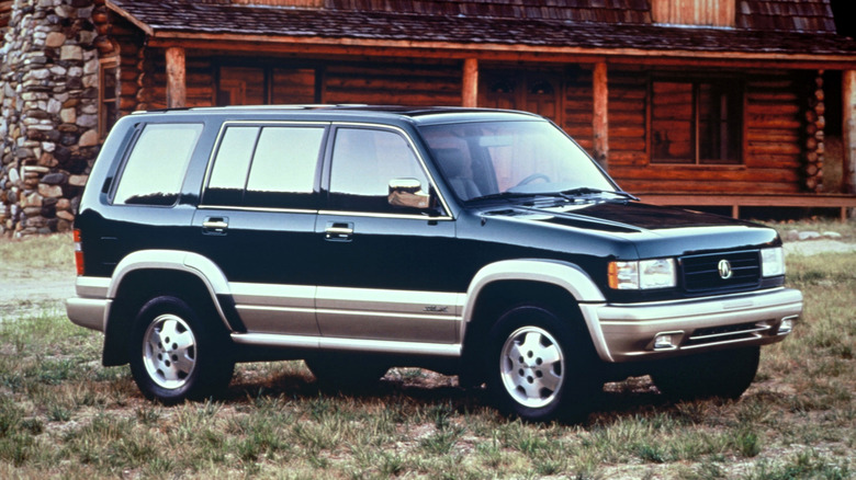 1997 Acura SLX SUV parked in front of cabin