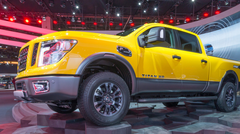 A yellow 2016 Nissan Titan XD truck at the North American International Auto Show