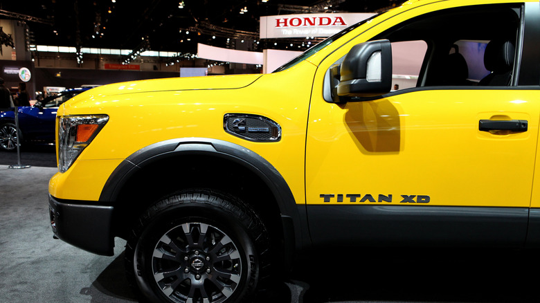 A yellow 2016 Nissan Titan XD on display at Chicago Auto Show