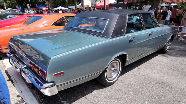 Rear 3/4 view of a classic Brazilian market Ford sedan, teal exterior, black vinyl roof