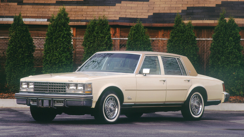 1976 Cadillac Seville sedan parked, front 3/4 view, beige exterior with a tan vinyl roof