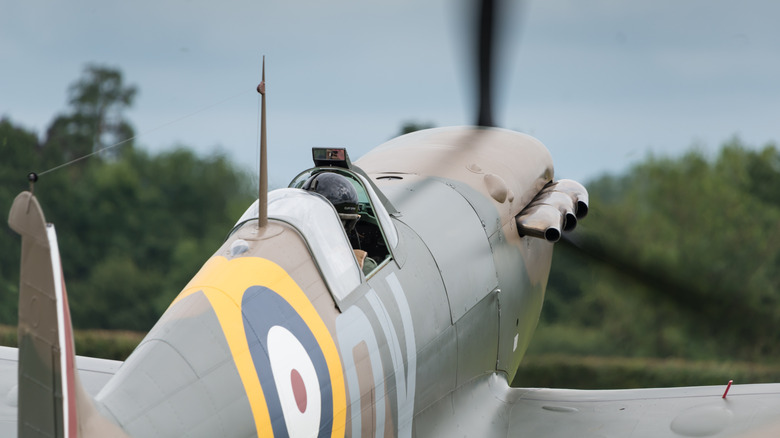 A Spitfire on the ground with propeller running