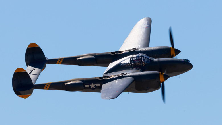 P-38 Lightning flying against blue sky background