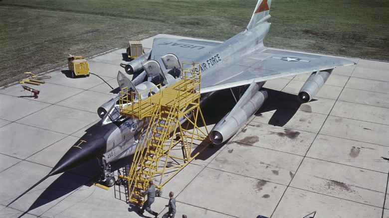 A Convair B-58 Hustler being worked on by technicians in 1960.