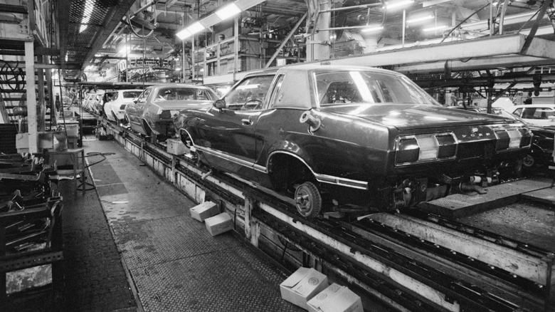 Cars travel along an American factory production line