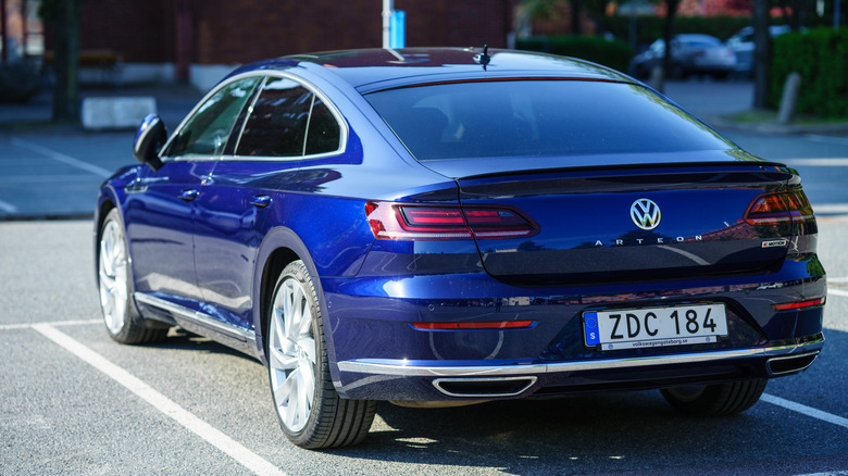 Rear view of a blue Volkswagen Arteon in a parking lot