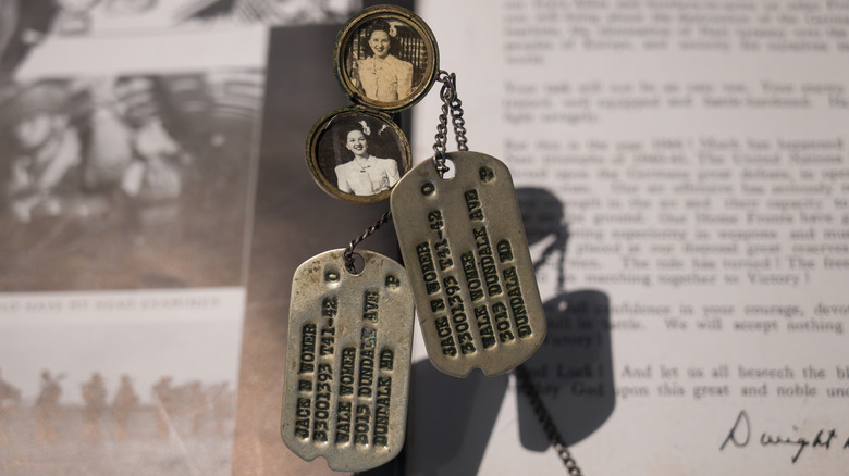 Detail of a soldier's identification chain with a souvenir photo of his wife.