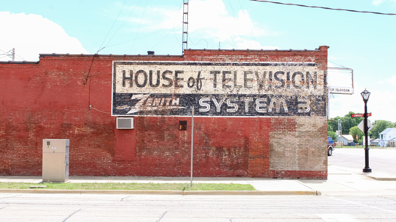 A faded Zenith advertisement painted on the side of a brick commercial building