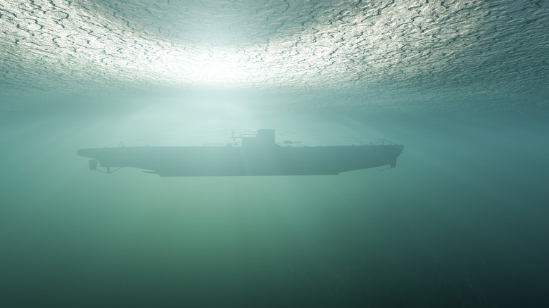 Side view of a submarine under the green water