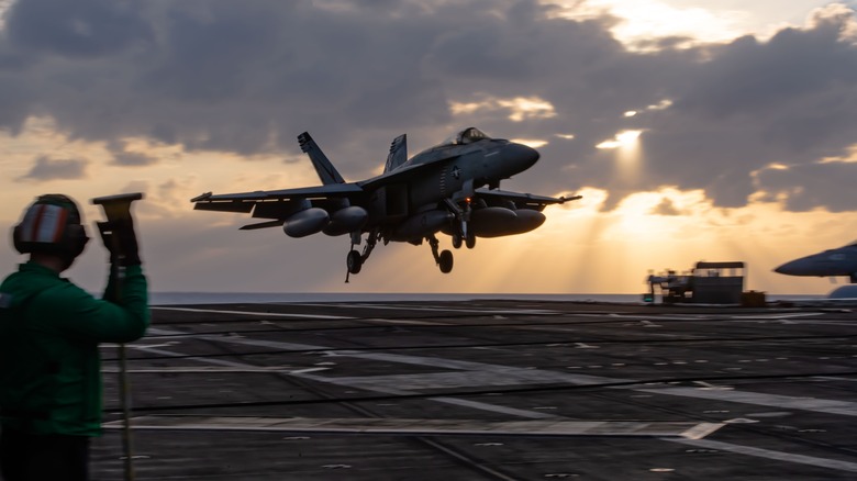 Plane landing on aircraft carrier