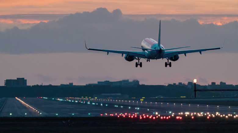 an airplane above the runway pointing towards the sky