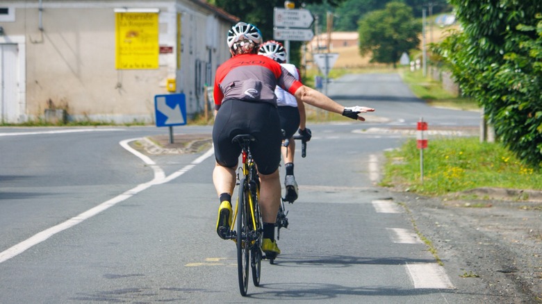 Cyclist indicating direction with right hand pointing out