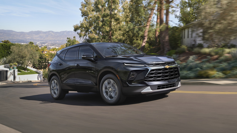 2026 Chevrolet Blazer in black driving through a residential area