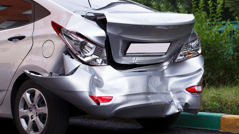 Rear view of car on street showing rear crumple zone after accident