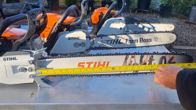 A man demonstrating the cutting area with and without the large bumper spikes