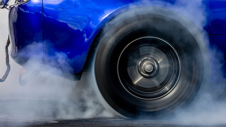 Close-up of right-rear tire on drag racer during a burnout