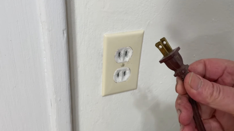 Polarized wall plug next to wall outlet
