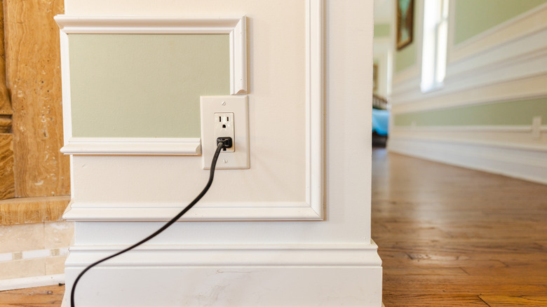 Two-prong power cord plugged into three-prong grounded polarized outlet