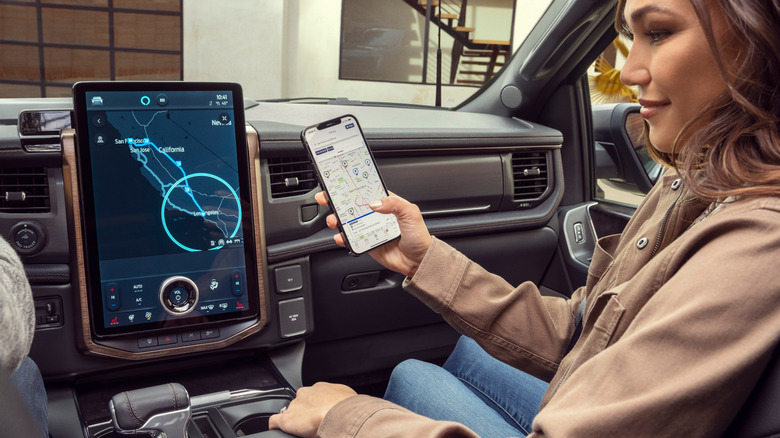 Woman using the infotainment system inside a car