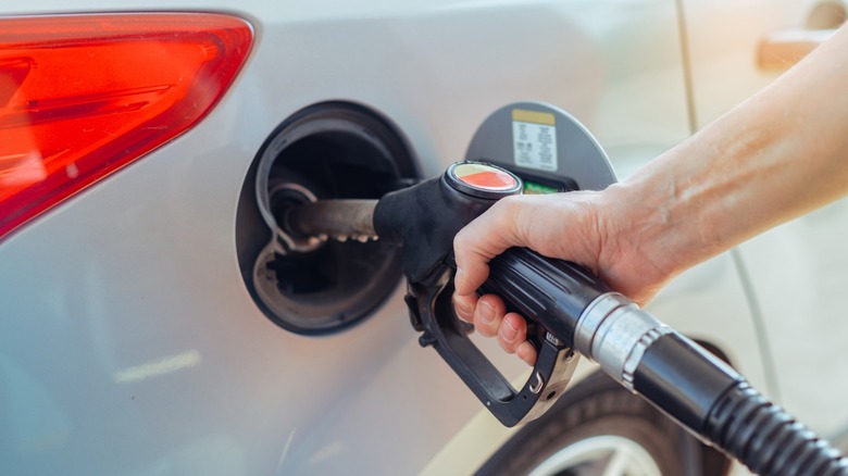Driver fuelling up at a gas station