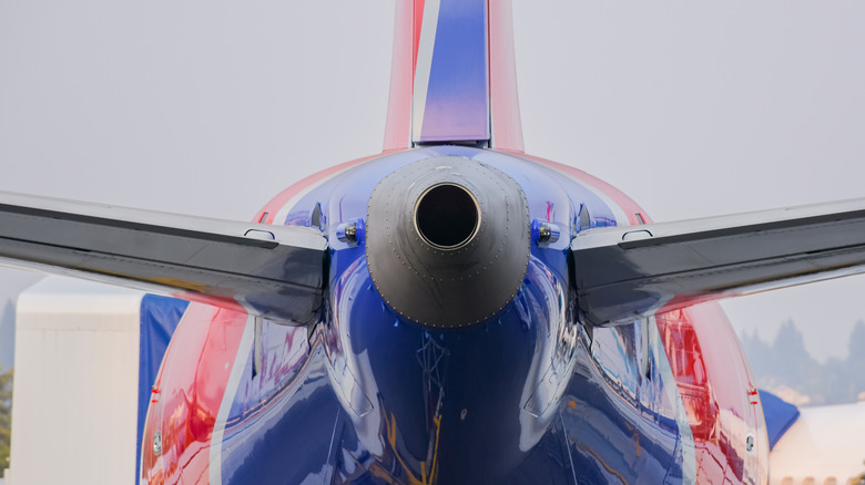 Close up of the back of a commercial airliner with the APU clearly visible