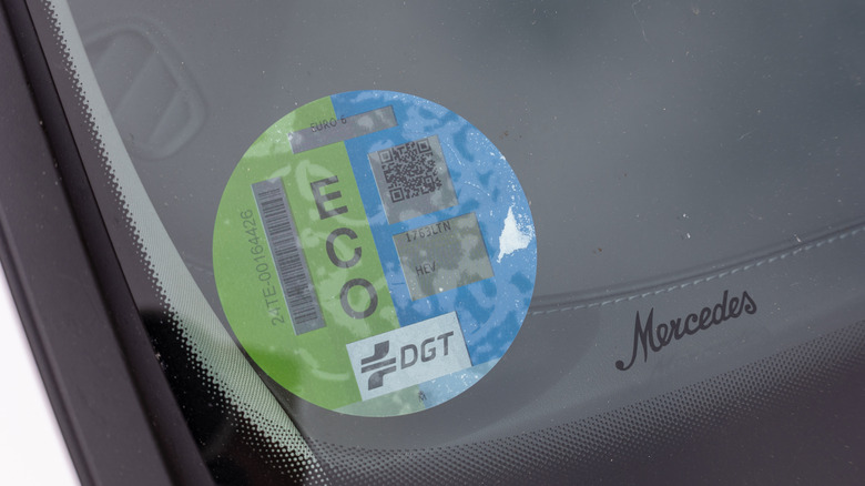 Mercedes script next to a Crit-Air sticker on windshield
