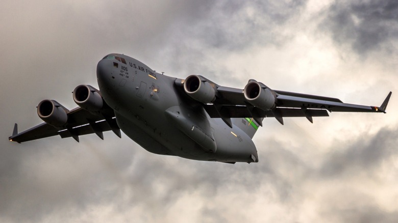 A Boeing C-17 Globemaster III flying on a cloudy day