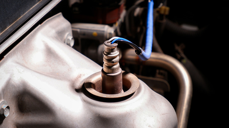An O2 sensor connected to an engine's exhaust manifold