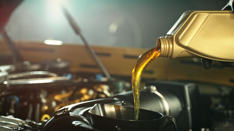 Motor oil being added to vehicle