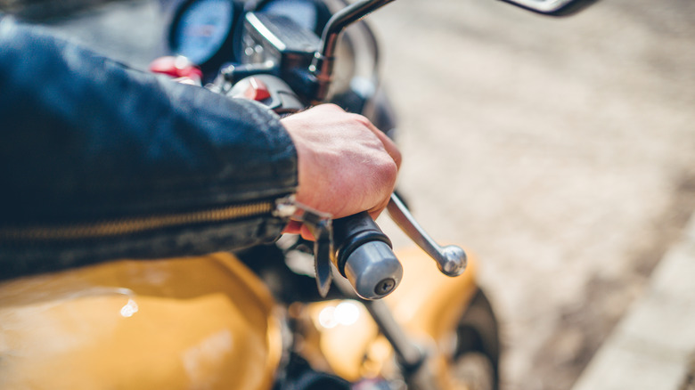 A motorcycle with a bar end weight installed on the handlebar