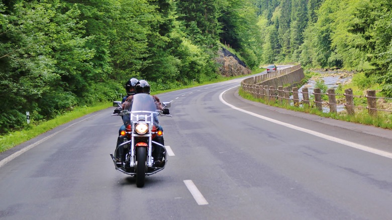 Motorcycle in the mountains drifting towards the left side of its lane.