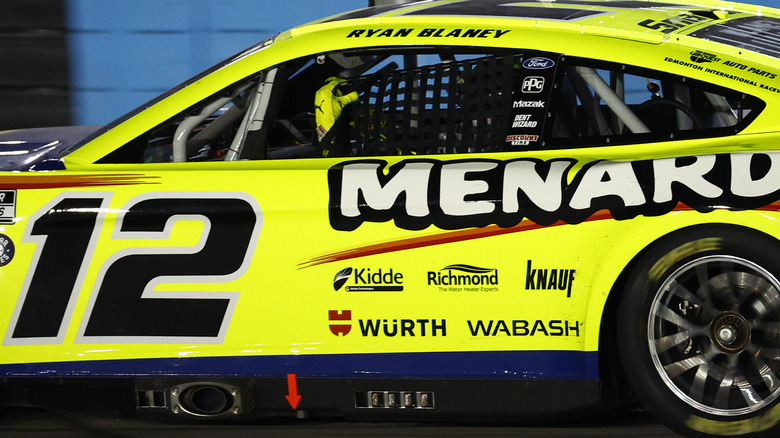 Ryan Blaney, driver of the #12 Menards/Wrangler Ford, attempts to replace his window net after a caution on the final lap and before overtime in the NASCAR Cup Series All-Star Race at Texas Motor Speedway on May 22, 2022 in Fort Worth, Texas.
