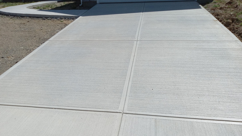 close-up of concrete driveway with perpendicular saw cuts